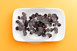 Cranberries on rectangular white plate with rounded corners.