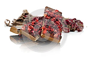 Cranberry chocolate with fruit pieces, on white background.