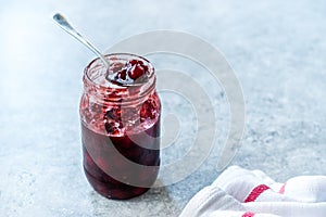 Cranberry Jam in Jar with Spoon / Cranberries Marmalade served with Bread Slices