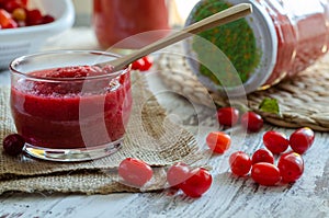 Cranberry marmelade  with fresh fruit on wooden background