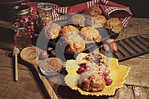 Cranberry muffins with berries on table