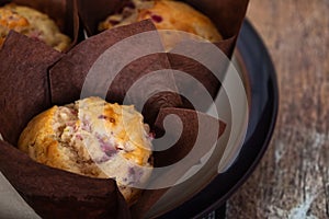 Cranberry orange muffins in brown tulip muffin liners