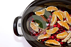 Cranberry sauce with oranges, cinnamon and bay leaf simmering in