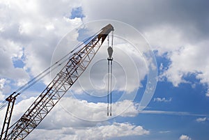 Crane against blue sky with clouds, Construction