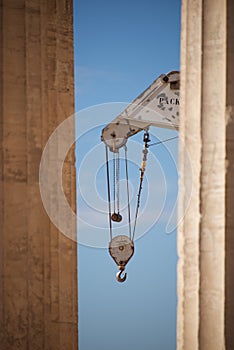 Crane appearing between two marble Parthenon columns