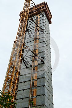 Crane attached to side of building at downtown construction site