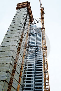 Crane attached to side of building at downtown construction site