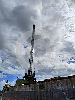 crane barge on the river against the background of blue sky and clouds 2