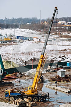 Crane beam machinery and bulldozer on building construction site