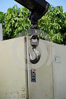 Crane boom with isolated hook, blue sky background,Elements of crane: hook, loop, chain, connecting parts