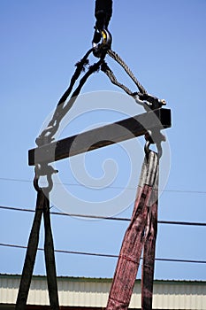 Crane boom with isolated hook, blue sky background,Elements of crane: hook, loop, chain, connecting parts