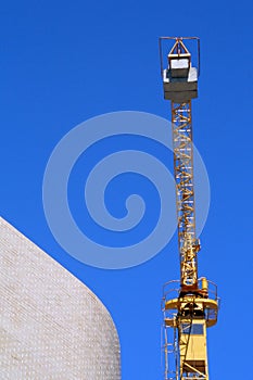 Crane with brick wall