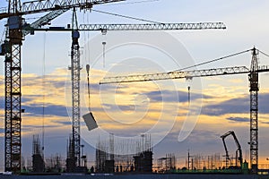 Crane of building construction against beautiful dusky sky