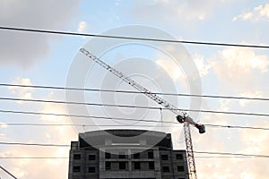 Crane and building construction site against blue sky