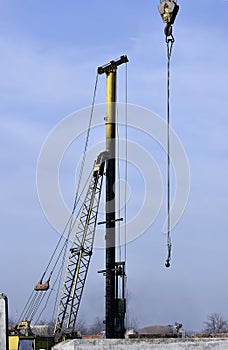 Crane and building construction site against blue sky