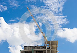 Crane and building construction site with blue sky