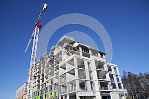 Crane and building construction site with blue sky background