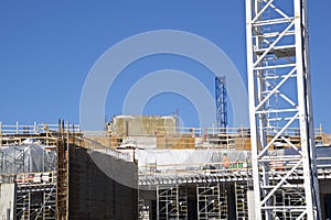 Crane and building construction site with building material