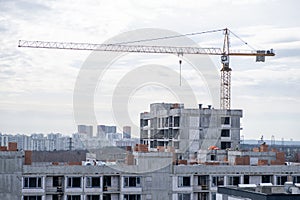 crane and a building under construction against a blue sky background