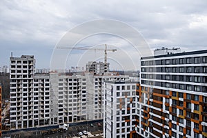 crane and a building under construction against a blue sky background