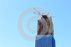 Crane and building under construction site