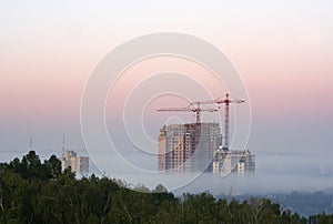 Crane with buildings in the morning