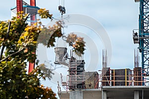 Crane with cement on building construction site