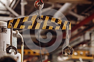 Crane chain and hook with blurred warehouse background. Concept production steel factory