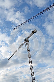 Crane, construction and clouds or blue sky background for building with heavy machinery or material outdoor. Hoist in