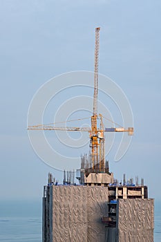 Crane in construction site on blue sky background