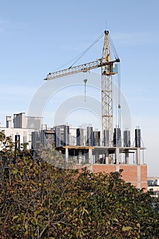 Crane at construction site in front of blue sky
