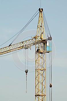 Crane at construction site in front of blue sky