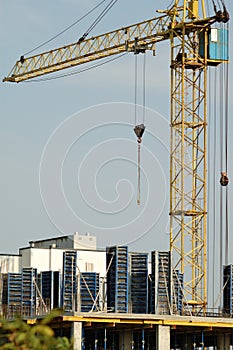 Crane at construction site in front of blue sky
