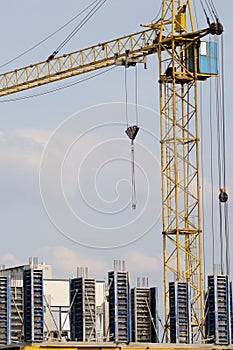 Crane at construction site in front of blue sky
