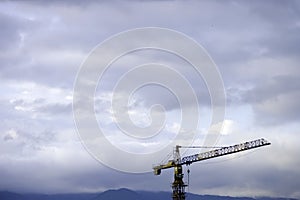 Crane Construction site in front of the cloudy sky