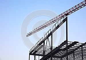 Crane on construction site metal structure tower