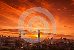 Crane in the construction site under the sunset