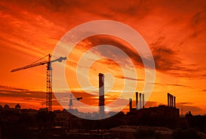 Crane in the construction site under the sunset