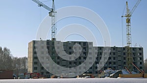 Crane on the construction site with workers by