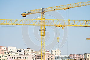 Crane and construction site working on building complex in Shenzhen China, infrastructure developing city concept