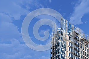 A crane in a construction work. Tall scaffold structure from below. Empty copy space