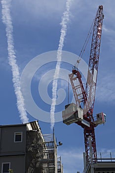 Crane with contrails in the Sky