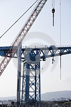Crane detail on construction building site lifting freight containers
