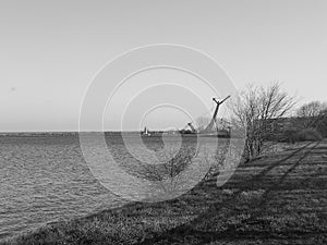 Crane e trance to the Port of Gdansk, Gulf of Gdansk, Baltic Sea. Artistic look in black and white.