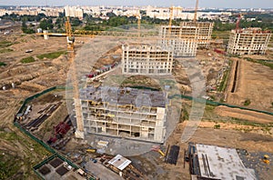 Crane during formworks. Aerial View of a large construction site. Tower cranes in action. Housing renovation concept. Construction