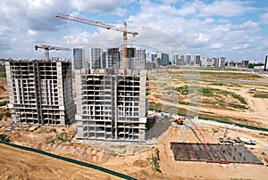 Crane during formworks on construction site. Tower cranes in action. Construction the buildings and multi-storey residential homes