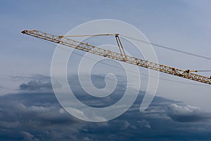 Crane girder over darl clouds