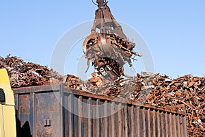 Crane grabber loading a Truck with metal scrap photo