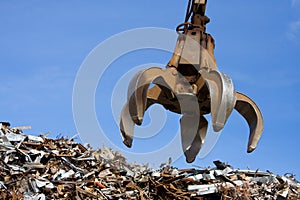 A crane grabber up on the metal heap