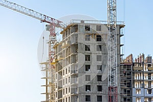 Crane and high-rise residential building. Real Estate Construction